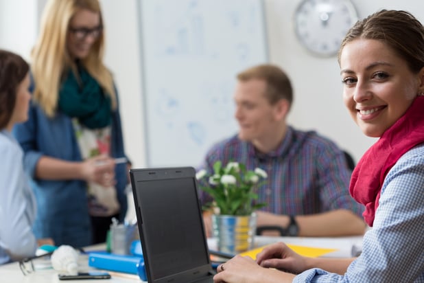 Portait of smiling young intern at office