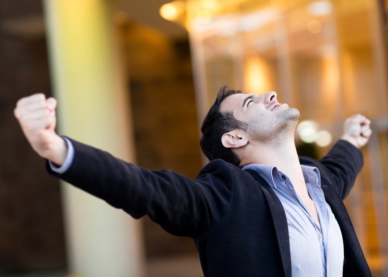 Successful businessman with arms up celebrating his victory.jpeg