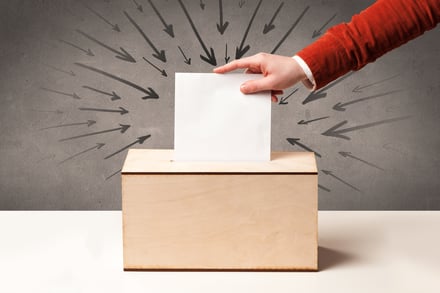close up of a ballot box and casting vote on grungy background